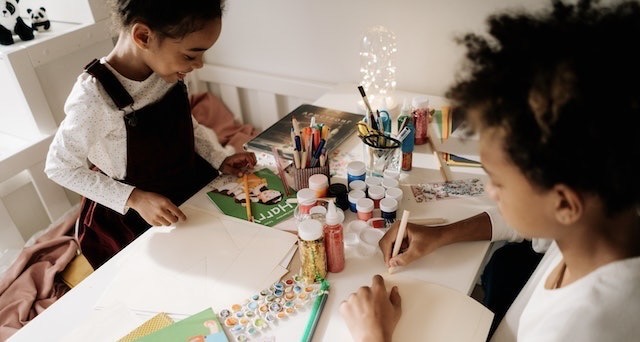 Children drawing on paper at the table